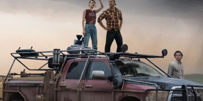 Three characters by a van in Twisters.