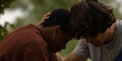 Two characters with their heads together in Black Dog.