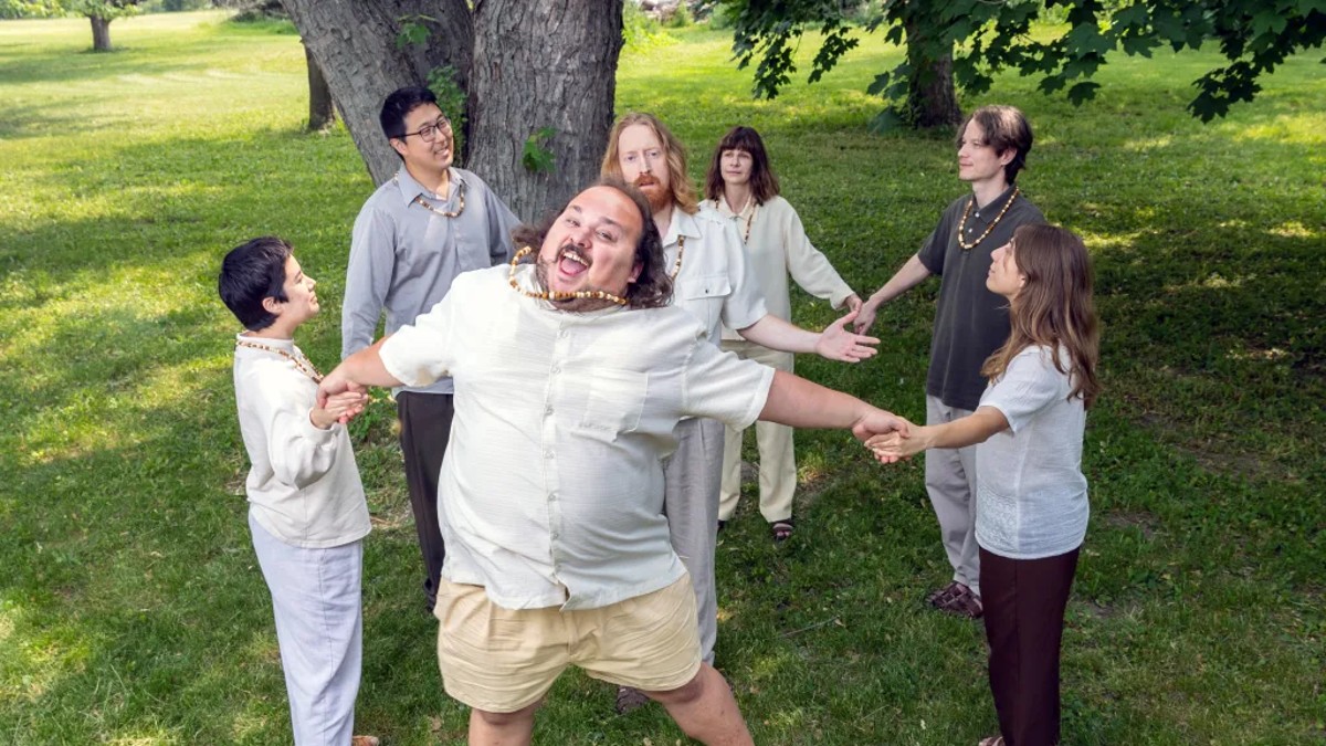 Characters stood in a circle holding hands in Let's Start a Cult.