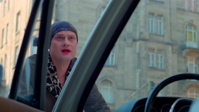 Elvira on the hood of a car in In a Year of 13 Moons.