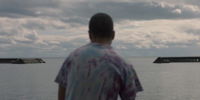 Z looking out to a body of water in Really Happy Someday.