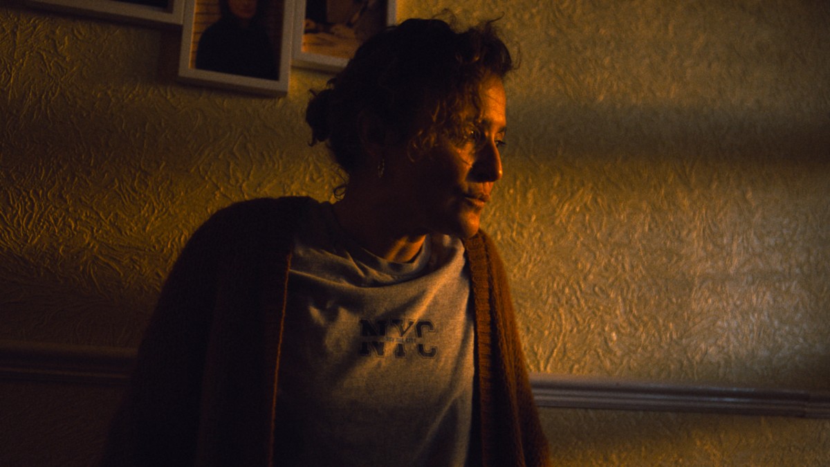 Nicky standing in her hallway in Restless.