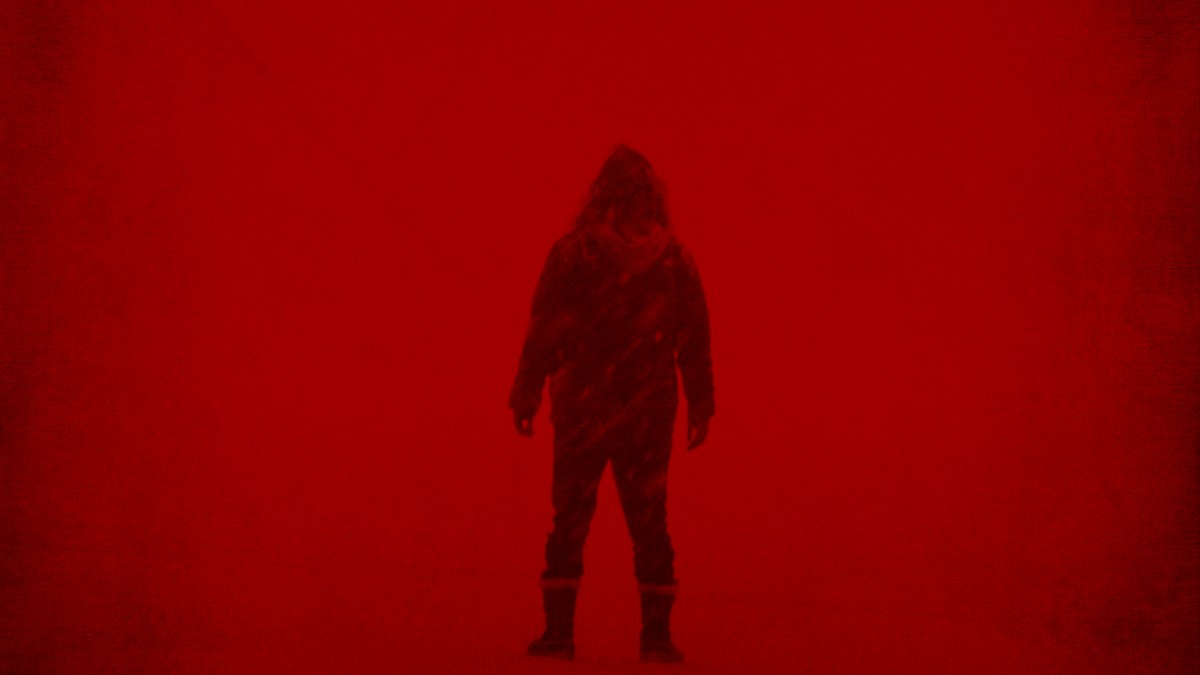 A character wading through red mist in Dream Eater.