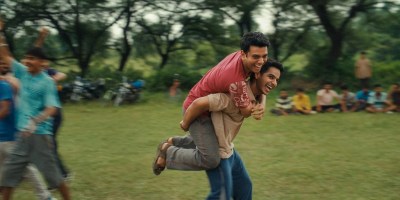The two main characters running through a field in Homebound.