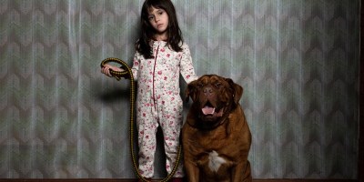 A child stood next to a dog in When Evil Lurks.
