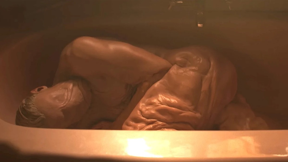 Matt Hagen in his Clayface form lying sprawled up in a bath.
